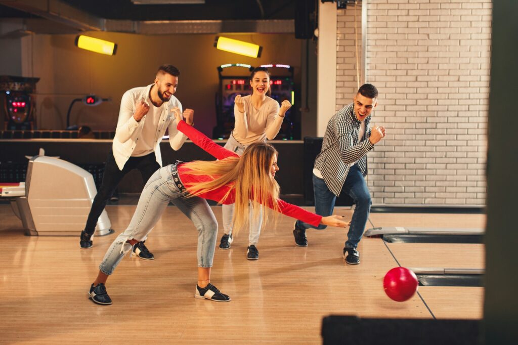 Group of young people having fun in a bowling alley