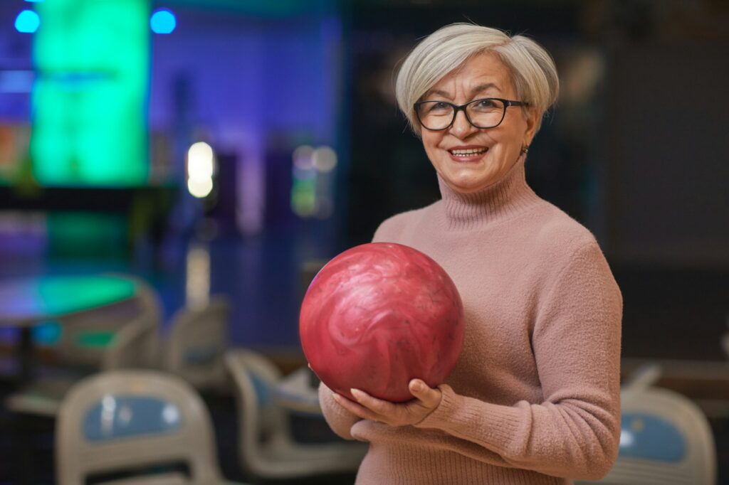 Senior Woman Holding Bowling Ball